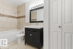 Bathroom with vanity, shower / washtub combination, light tile patterned floors, and a closet - 