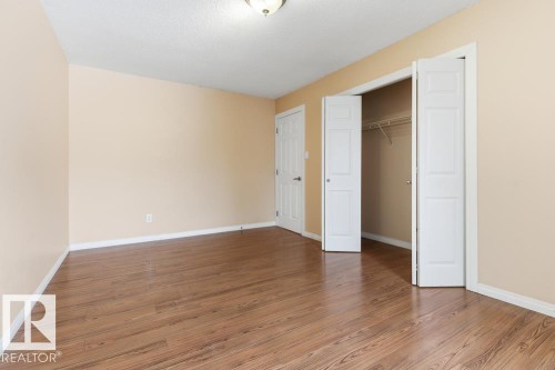 Unfurnished bedroom with light wood-style floors and a closet - 196 Roseland Village, Edmonton, AB - Indoor Photo Showing Other Room
