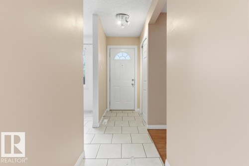 Doorway with a textured ceiling and tile patterned flooring - 196 Roseland Village, Edmonton, AB - Indoor Photo Showing Other Room