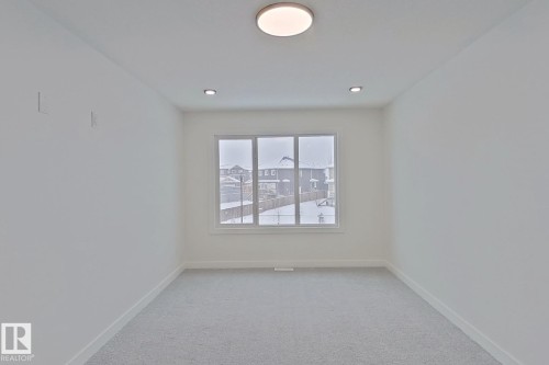 Spare room with baseboards and light colored carpet - 3158 Magpie Way, Edmonton, AB - Indoor Photo Showing Other Room