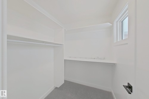 Walk in closet with dark colored carpet - 3158 Magpie Way, Edmonton, AB - Indoor With Storage