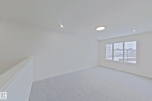 Unfurnished room featuring light carpet and recessed lighting - 3158 Magpie Way, Edmonton, AB - Indoor Photo Showing Other Room