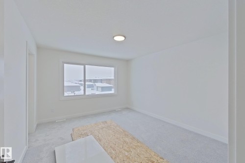 Carpeted spare room featuring baseboards - 3158 Magpie Way, Edmonton, AB - Indoor Photo Showing Other Room