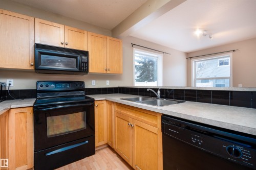 111 230 Edwards Drive, Edmonton, AB - Indoor Photo Showing Kitchen With Double Sink