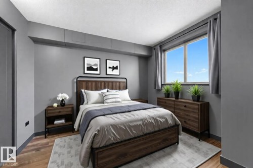 Bedroom featuring wood finished floors and a textured ceiling - 1702 10150 117 Street, Edmonton, AB - Indoor Photo Showing Bedroom