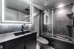 Full bathroom featuring vanity, enclosed tub / shower combo, and backsplash - 