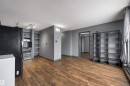 Unfurnished living room featuring a textured ceiling, dark wood finished floors, and baseboard heating - 1702 10150 117 Street, Edmonton, AB  - Indoor Photo Showing Other Room 