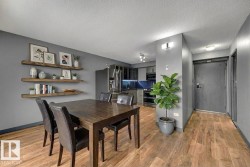 Dining room with a textured ceiling and light wood finished floors - 