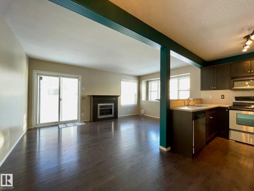 78 230 Edwards Drive Sw, Edmonton, AB - Indoor Photo Showing Kitchen With Fireplace