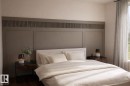 Bedroom with wood finished floors and a decorative wall - 9237 102 Street, Morinville, AB  - Indoor Photo Showing Bedroom 
