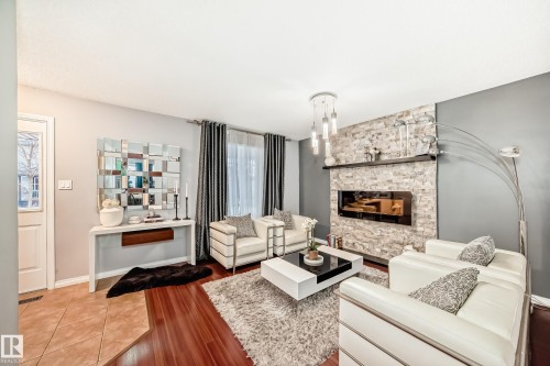 5819 Sutter Place, Edmonton, AB - Indoor Photo Showing Living Room With Fireplace