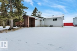Snow covered house with a deck and stairs - 