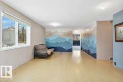 Unfurnished room with an accent wall and wood finished floors - 