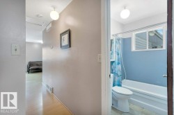 Full bath with shower / tub combo and a textured ceiling - 