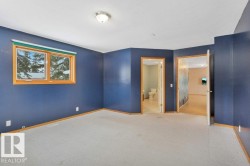 Unfurnished bedroom featuring carpet floors and ensuite bathroom - 