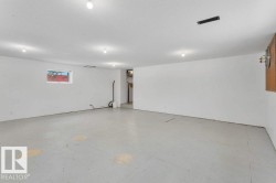 Basement featuring a textured ceiling - 