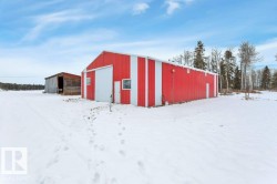 Snow covered structure with an outbuilding - 