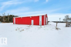 Snow covered structure with an outbuilding - 