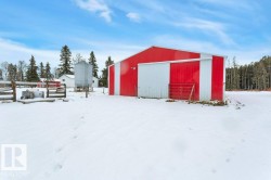Snow covered structure with a pole building - 