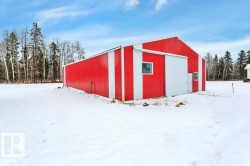 Snow covered structure with a pole building - 