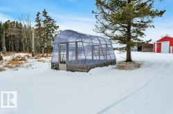 Snow covered structure with a greenhouse - 