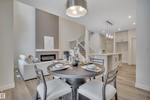 304 Juniper Cove, Leduc, AB - Indoor Photo Showing Dining Room With Fireplace