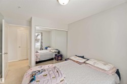 Carpeted bedroom featuring a textured ceiling and a closet - 