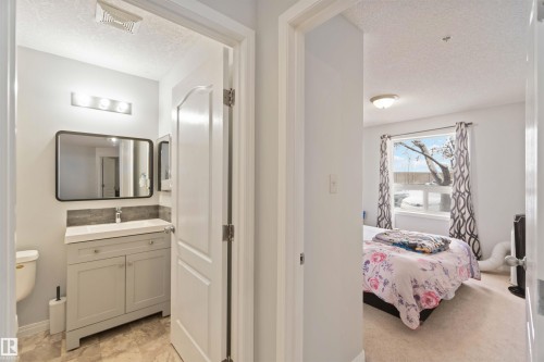 Ensuite bathroom with a textured ceiling and vanity - 2117 9357 Simpson Drive, Edmonton, AB - Indoor
