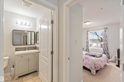 Ensuite bathroom with a textured ceiling and vanity - 