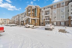 Snow covered property featuring a view of apartment building / complex - 