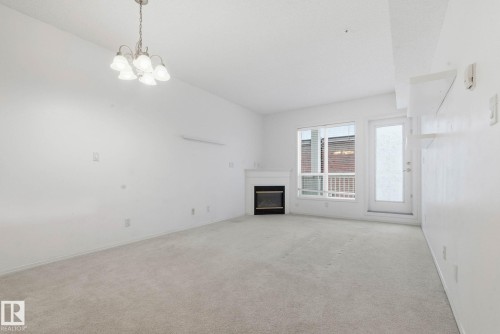 305 8488 111 Street, Edmonton, AB - Indoor Photo Showing Other Room With Fireplace
