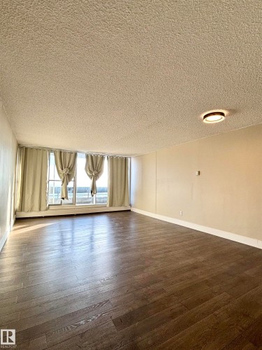 Spare room with a textured ceiling and dark wood-type flooring - 133 8735 165 Street, Edmonton, AB - Indoor