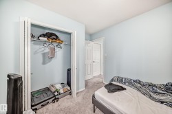 Bedroom featuring light carpet and a closet - 