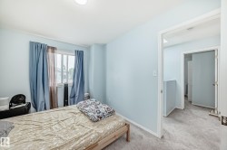 Bedroom with light colored carpet and baseboards - 