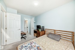 Bedroom with light carpet and a desk - 
