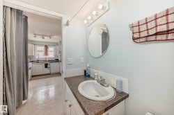 Bathroom featuring vanity, a textured ceiling, and light flooring - 