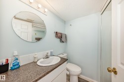 Half bath with a textured ceiling and vanity - 