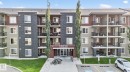 View of apartment building / complex featuring uncovered parking - 414 12035 22 Avenue, Edmonton, AB  - Outdoor With Facade 