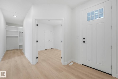 Foyer entrance featuring light wood-style floors and recessed lighting - 3140 Magpie Wy, Edmonton, AB - Indoor Photo Showing Other Room
