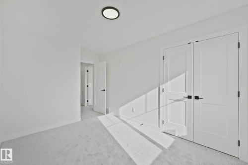 Unfurnished bedroom with light carpet and a closet - 3140 Magpie Wy, Edmonton, AB - Indoor Photo Showing Other Room
