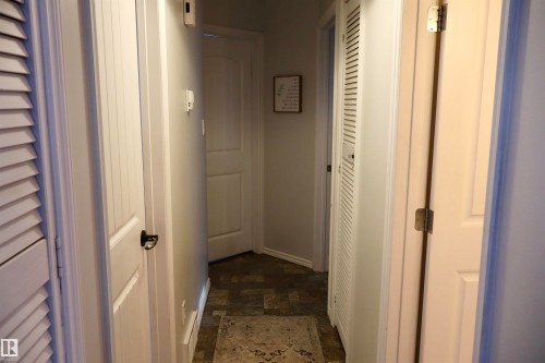Hallway with stone finish floors and baseboards - 4505 58 Avenue, Barrhead, AB - Indoor Photo Showing Other Room