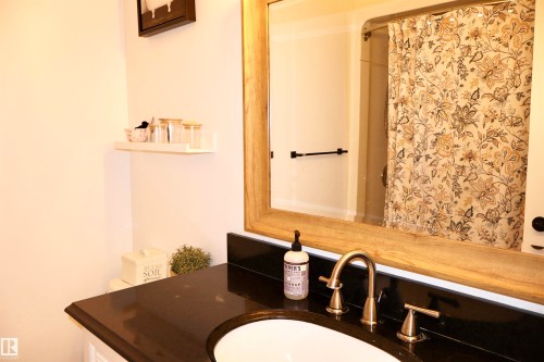 Full bath with vanity and curtained shower - 4505 58 Avenue, Barrhead, AB - Indoor Photo Showing Bathroom