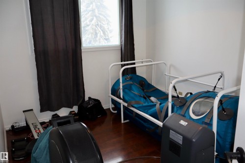 Workout room featuring dark wood-style flooring - 4505 58 Avenue, Barrhead, AB - Indoor