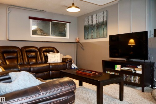 Living area featuring carpet flooring and a textured ceiling - 4505 58 Avenue, Barrhead, AB - Indoor