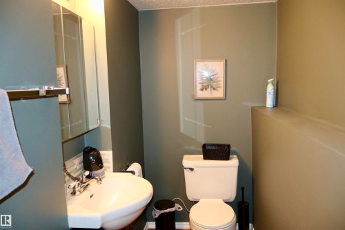 Half bath featuring toilet and a textured ceiling - 4505 58 Avenue, Barrhead, AB - Indoor Photo Showing Bathroom