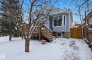 View of front of home with a chimney, a wooden deck, a gate, and stairway - 9705 87 Avenue, Edmonton, AB  - Outdoor 