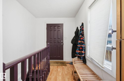 Foyer entrance featuring light wood-type flooring and a textured ceiling - 9705 87 Avenue, Edmonton, AB - Indoor Photo Showing Other Room