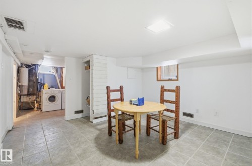 Bonus space featuring washer and dryer and light tile patterned floors - 9705 87 Avenue, Edmonton, AB - Indoor Photo Showing Other Room