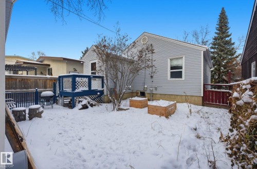 Snow covered rear of property with a deck - 9705 87 Avenue, Edmonton, AB - Outdoor With Exterior