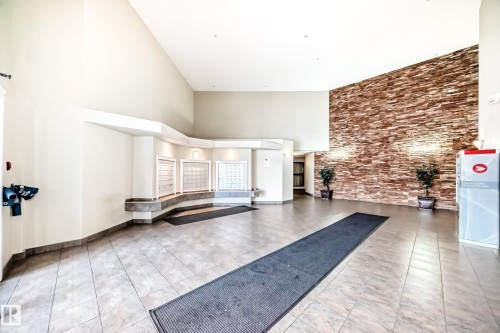 223 5350 199 Street, Edmonton, AB - Indoor Photo Showing Other Room With Fireplace